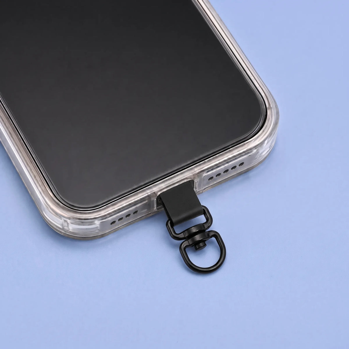 Alma Grip: placa con anilla giratoria saliendo por la parte inferior de una funda transparente